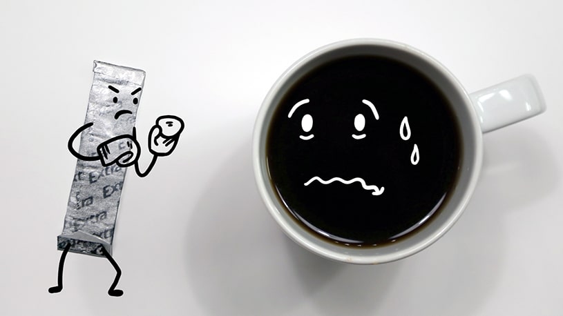 A drawn character shaped like a sugar packet angrily holds a sugar cube in front of a coffee cup with a sad, tearful face.